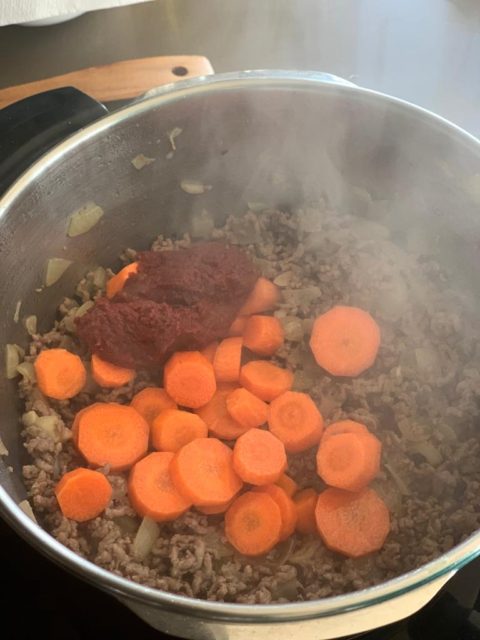 Add carrots and tomato paste