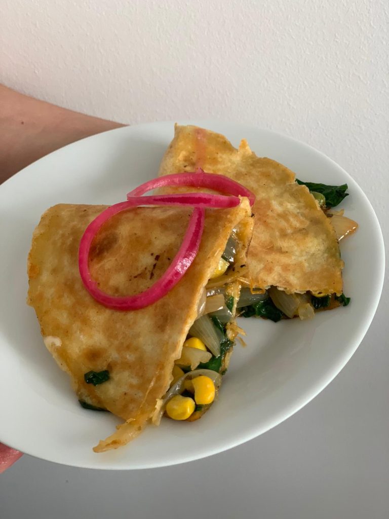 Pickled onions on spinach quesadilla