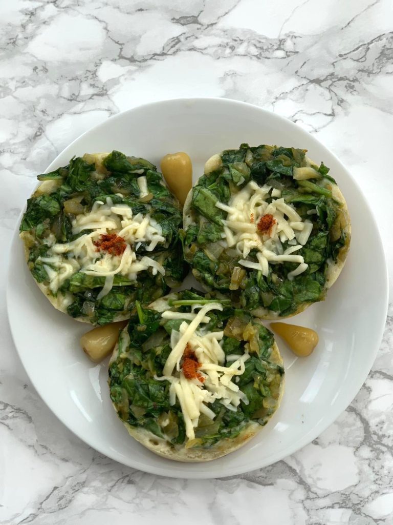 Savory mini pancakes with spinach topping